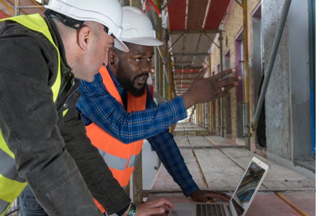 two men discussing construction plans